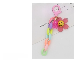 Detail of colorful acrylic chain with cute pink resin bear and sunflower charms