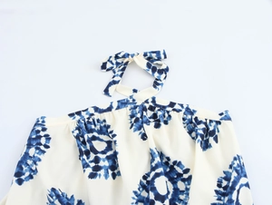 Detail of blue and white tie-dye halter neckline with an elegant bow-tie closure