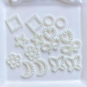 Assorted white faux pearl charms in bow, heart, and star shapes for DIY hair accessories