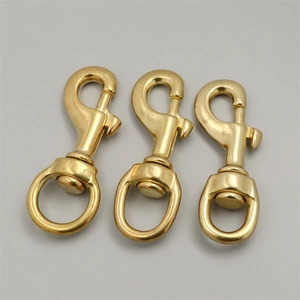Macro shot of three solid brass swivel snap hooks for leather craft and bags