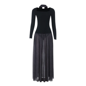 Close-up of the sheer polka dot fabric and mesh patchwork on the black A-line dress