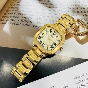 Retro square gold watch with Roman numerals on a classic book page background