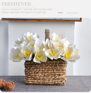 Close-up of white 3D printed cymbidium orchids in a rustic woven rattan flower basket