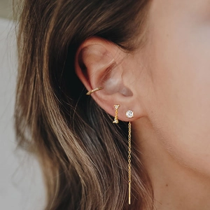 Detailed close-up of s925 silver butterfly tassel ear cuff and gold chain earrings