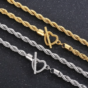 Detail view of gold and silver twist chain necklaces with heart-shaped OT toggles