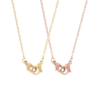 Macro detail of gold and rose gold stainless steel box chain necklaces with lobster clasps