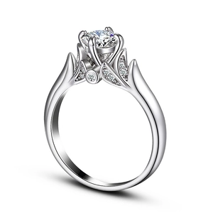 Detail view of a classic six-prong set round cubic zirconia ring with leaf-shaped accents