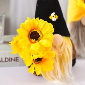 Macro shot of bee gnome plush with sunflower detail and black hat for home decor