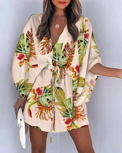 Detail of V-neck summer dress with tropical leaf print and adjustable waist drawstring