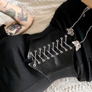 Detailed view of a wide black PU leather corset belt with metal chain and butterfly charm
