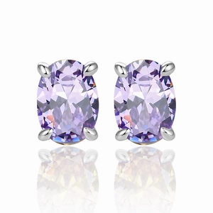 Macro shot of oval purple zircon earrings with silver four-prong setting and reflections