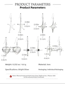 Detail of silver-tone iron earrings featuring star, heart, and tassel fringe designs