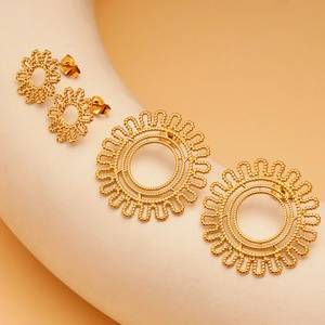 Detail of gold sunflower earrings with beaded texture on a geometric display