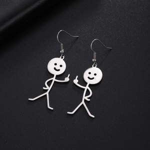 Macro shot of silver stickman dangle earrings with middle finger gesture on black texture