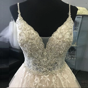 Elegant spaghetti strap V-neck bridal gown with floral lace and beaded details