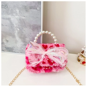 Close-up of pink leopard plush bag with pearl handle and golden chain strap