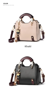 Close-up of khaki and black stylish handbags with red handles and calf charm pendants