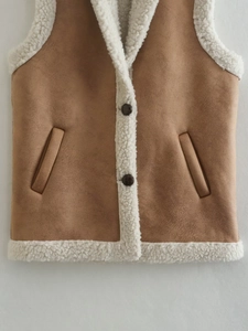 Detail of faux suede vest with plush faux shearling lining and button closure