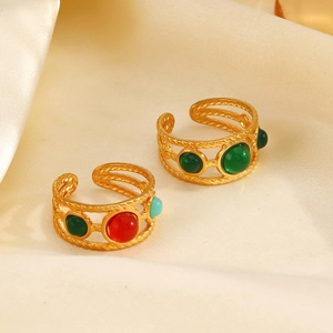 18K gold-plated braided resin rings with colorful gemstones on silk fabric background