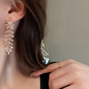 Elegant gold-tone long fringe drop earrings with pink zircon floral tassels on model