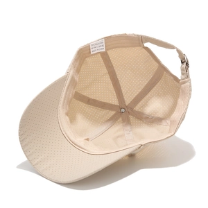 Detail view of breathable polyester mesh cap interior with adjustable buckle and label