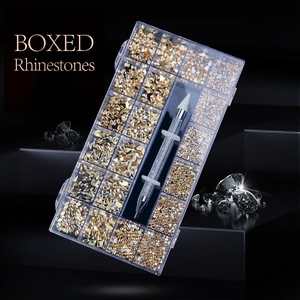 Macro detail of a 21-compartment nail art rhinestone set with a double-ended wax pen tool