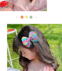 Detailed view of colorful sequin bow hair clip for girls with vibrant rainbow sparkle