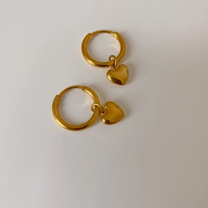 Gold heart drop hoop earrings in minimalist style with polished titanium steel finish