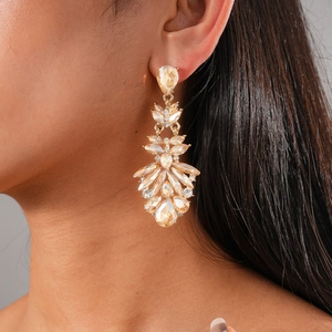 Detail shot of vintage style chandelier drop earrings with champagne crystals on a model