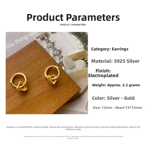 Macro view showing 12mm S925 sterling silver golden heart hoop earrings on wood base