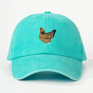 Close-up of brown hen embroidery on a teal washed cotton canvas baseball cap