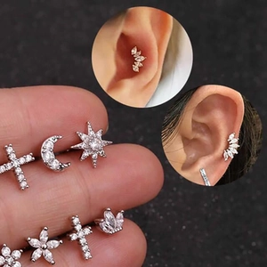 Macro shot of 925 sterling silver stud set with zircon star moon and leaf designs