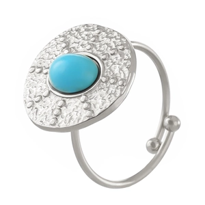 Silver vintage turquoise adjustable ring with a hammered oval disk on a white background