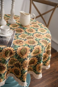 Close-up of yellow sunflower jacquard tablecloth with decorative fringe edge details