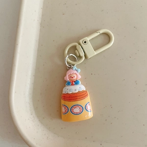Detail of cute resin cartoon girl keychain with yellow bunny jar and D-shaped buckle