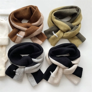 Flat lay view of ribbed knit scarves in contrast colors showing the thick texture