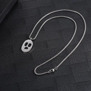 Detailed close-up of dark style ghost pendant with black claw marks on box chain