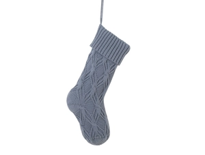 Detail of cable knit pattern and ribbed cuff on a blue-gray Christmas stocking with loop