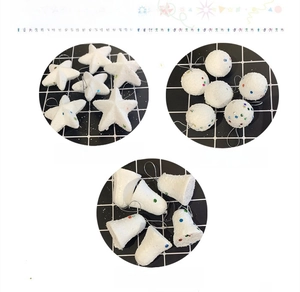 Detail of glittery foam Christmas star, ball, and bell ornaments with snow texture