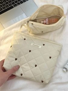 Quilted off-white makeup bag set with brown heart embroidery and seashell labels