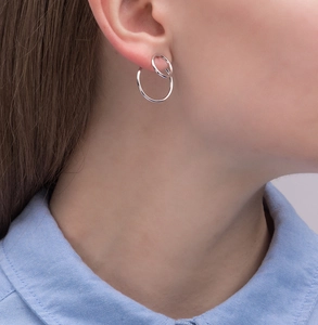 Macro detail of minimalist S925 silver double hoop earrings worn by a model
