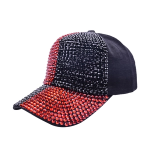 Detail of baseball cap showing contrast red and black rhinestones on crown and brim