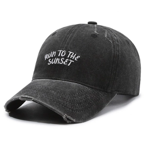 Vintage washed black baseball cap with distressed details and RUN TO THE SUNSET embroidery