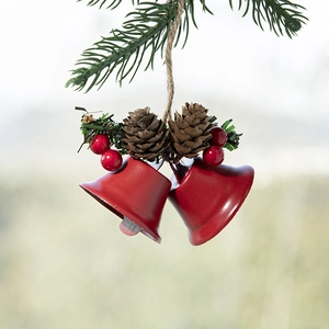 Nordic Christmas bell ornament with red metal bells, pine cones and red berries on a branch