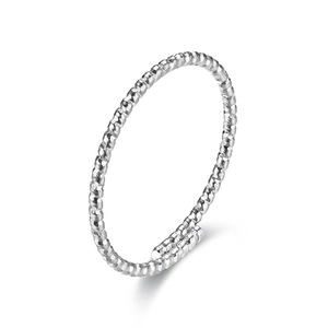 Macro detail of silver titanium steel ring with unique hammered texture and twist design