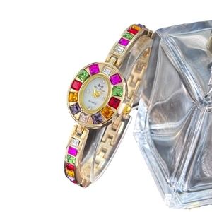 Exquisite gold quartz watch for women with colorful zircon crystals and white dial