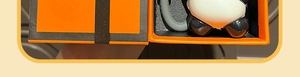 Close-up of cute cartoon panda keychain charm inside a luxury orange gift box