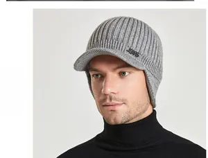 Detail view of gray ribbed knit beanie with ear flaps and metal JEANS emblem accent
