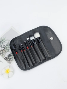 7pcs makeup brushes with redwood handles and black leather roll bag shown on white background