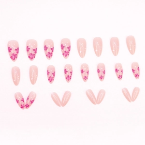 Faux ongles fleurs de cerisier roses avec points blancs et paillettes forme amande